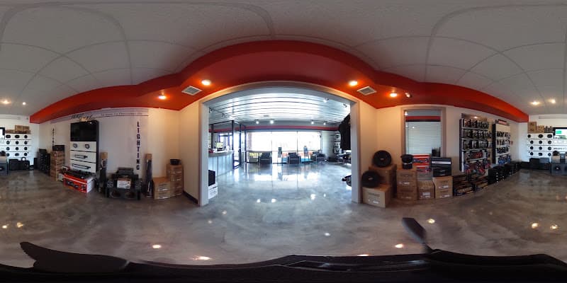 Panoramic showroom view with speaker displays and a red ceiling arch at 316 CUSTOMS in Wichita, Kansas