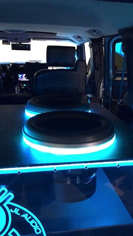 Two subwoofers with blue LED rings in a van cargo area at King's Kustoms Car Stereo & Security in Broken Arrow, Oklahoma