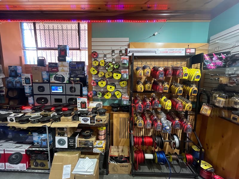 Shop interior with speakers, subwoofers and wire spools on shelves at RJ Distributing in Philadelphia, Pennsylvania