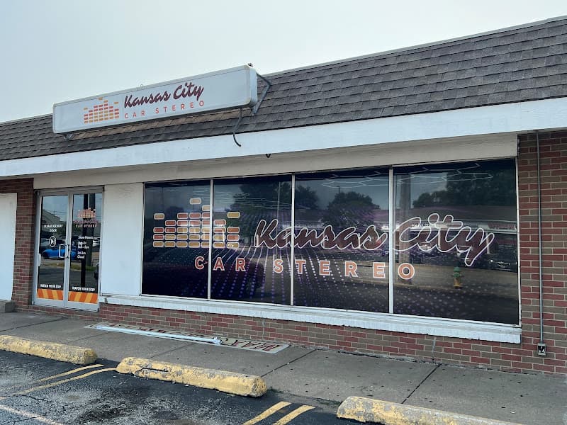 Storefront with a logo sign and large window graphics at Kansas City Car Stereo in Kansas City, Missouri