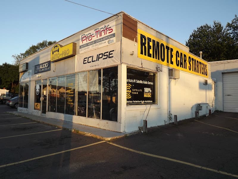 Shop front with yellow Remote Car Starters banner and Eclipse sign at Auto-Pro in Hamden, Connecticut
