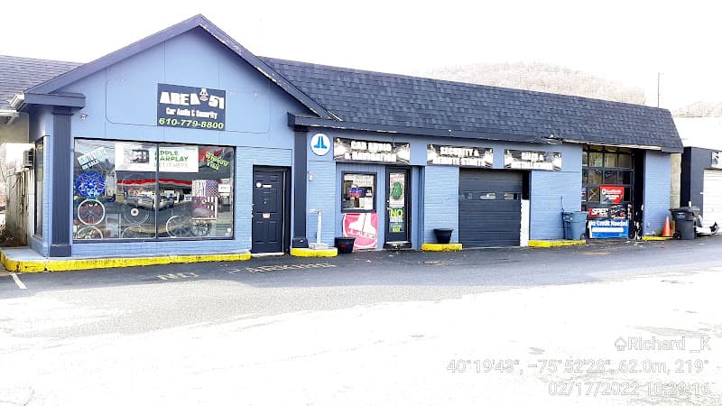 Blue-gray storefront with AREA 51 sign and roll-up door at Area 51 Car Audio & Security in Reading, Pennsylvania
