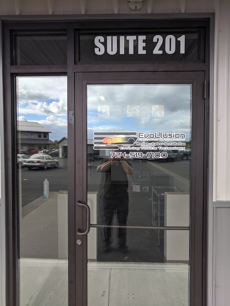 Glass office door marked Suite 201 with logo decal at Evollusion Electronics & Accessories in Export, Pennsylvania