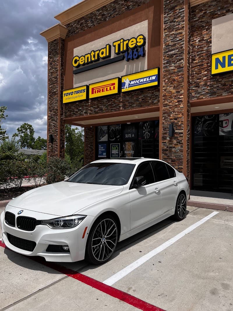 White BMW sedan parked outside Central Tires storefront at Beats Car Audio in Richmond, Texas