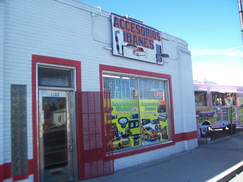 White brick storefront with red trim and car audio posters in the window at Accesorios Ibanez in Reno, Nevada