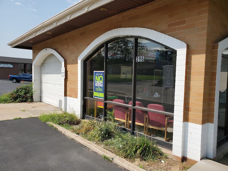 Brick storefront with arched window and no credit needed sign at MR Audio in Centerville, Utah