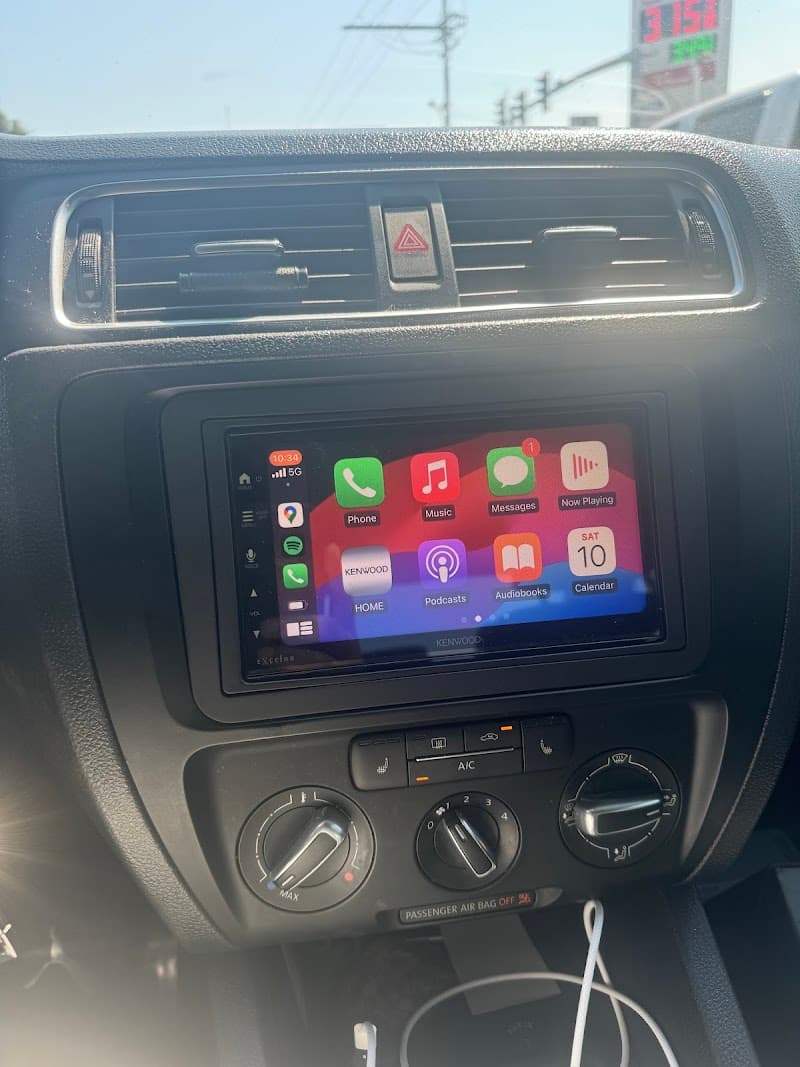 Kenwood touchscreen showing CarPlay on a car dashboard at Mobile-One Auto Sound in Gretna, Louisiana