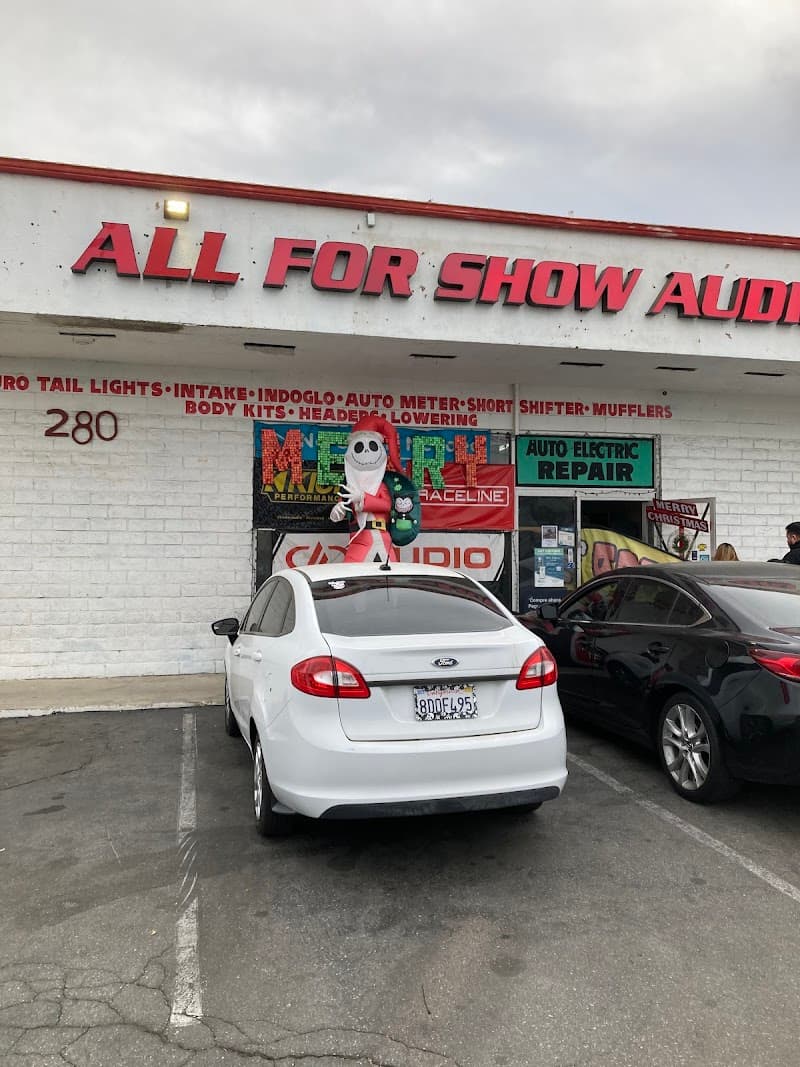 Storefront with red sign and two cars parked out front at All For Show Audio in Hemet, California