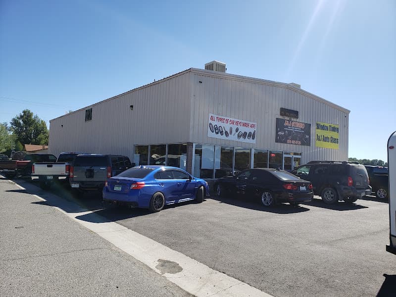 Metal shop building with cars parked out front at J&j stereo auto glass window tint and locksmith in Delta, Colorado
