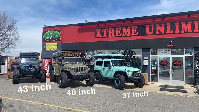 Three lifted off-road SUVs labeled 43, 40 and 37 inch at Xtreme Unlimited in Thornton, Colorado