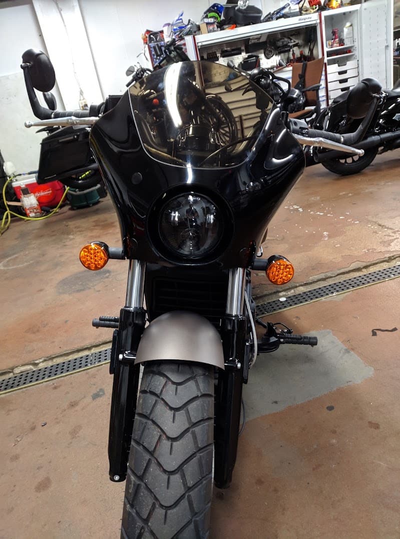 Black motorcycle with fairing and round headlight, front view at Hollywood Sound Audio in Newburgh, New York