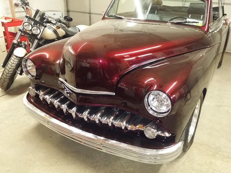 Dark red vintage sedan with chrome grille, front three-quarter view at Audio by Adam in Milton, New York