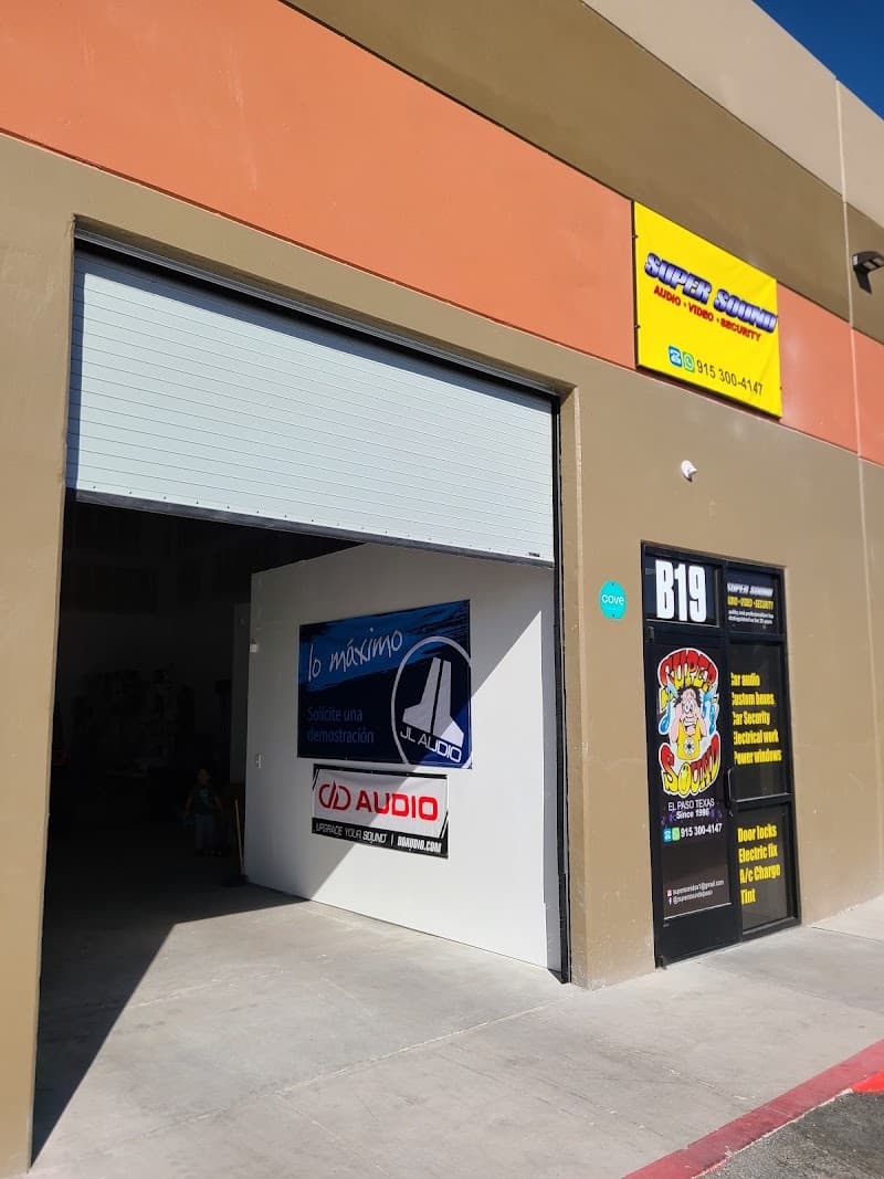 Storefront with open roll-up bay and JL Audio and DD Audio signs at Super Sound - Car Audio in El Paso, Texas