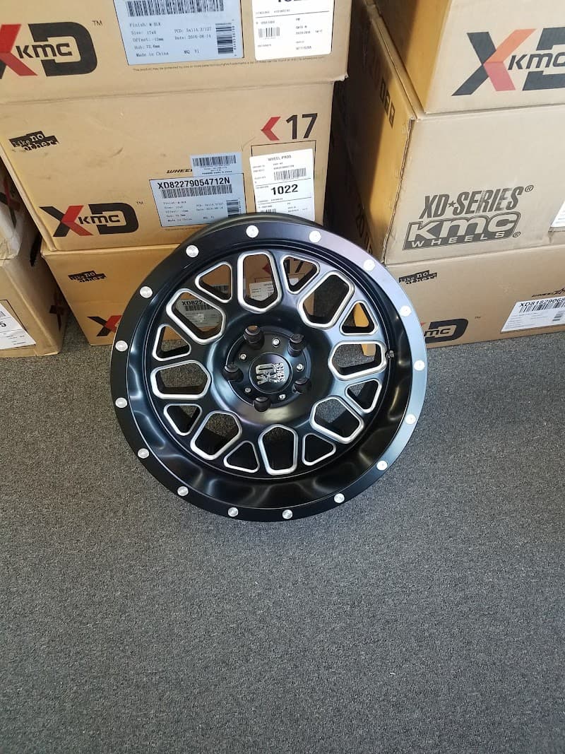Black wheel with machined spokes in front of KMC XD boxes at Hammer Electronics in Kingston, New York
