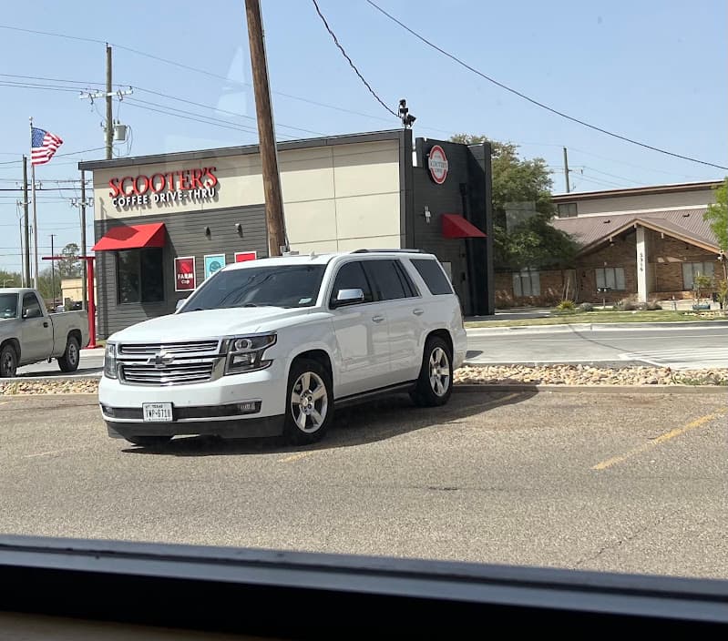 White Chevrolet SUV parked in a lot, front three-quarter view at Audio Craft in Lubbock, Texas