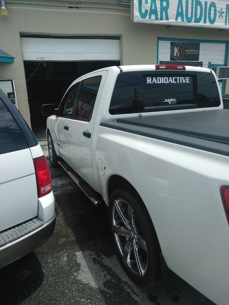 White pickup truck with Radioactive decal on rear window at Radioactive Car Audio in Largo, Florida