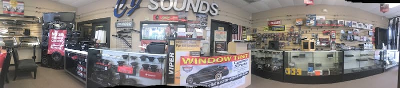 Panoramic shop interior with speaker displays and a window tint sign at CJ Sounds in Katy, Texas