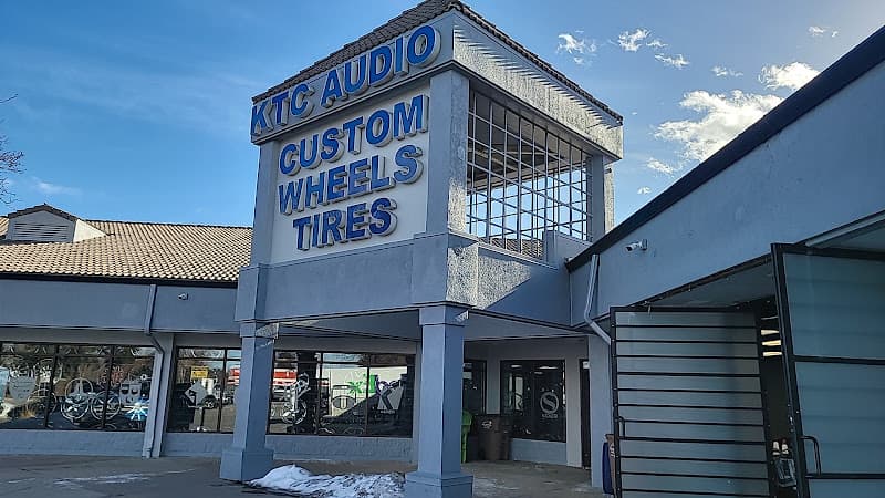 Storefront with blue lettered sign and glass windows at KTC Audio Custom Wheels & Tires in Aurora, Colorado
