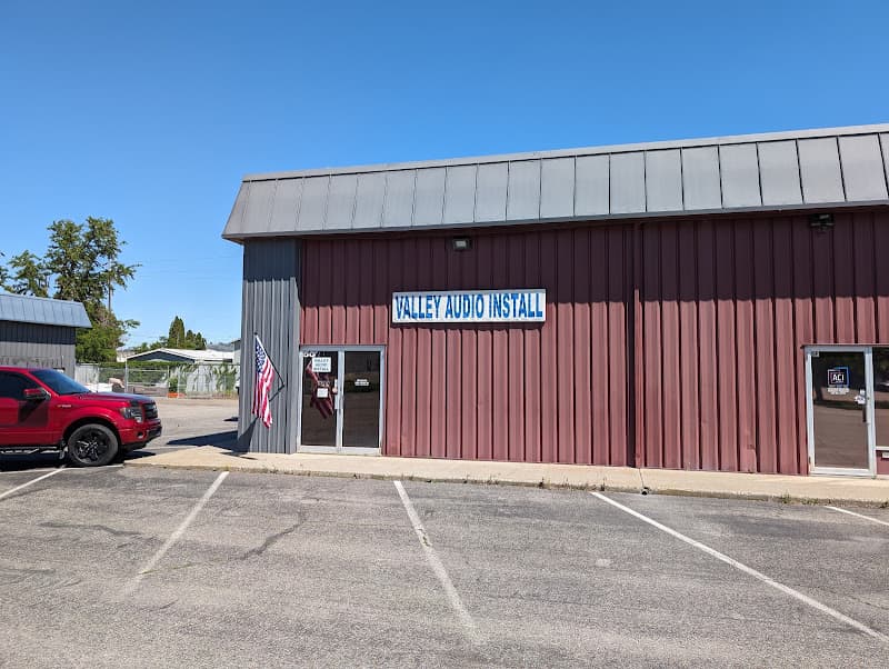 Red metal storefront with flag and red pickup parked out front at Valley Audio Install in Spokane Valley, Washington