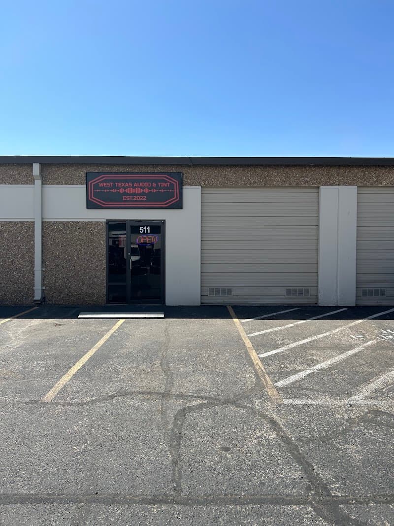 Storefront with two roll-up bay doors and a glass entrance at West Texas Audio and Tint in El Paso, Texas
