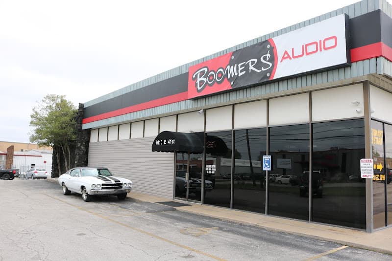 Storefront with a red and black sign and tinted windows at Boomers Audio in Tulsa, Oklahoma