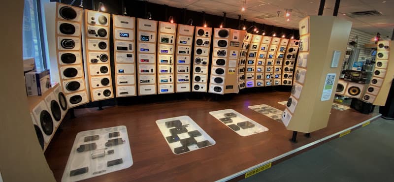 Showroom wall of speaker and stereo displays with floor cases at Safe & Sound Mobile Electronics in Chantilly, Virginia