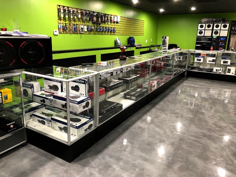 Glass cases of car speakers and audio gear in a showroom at Kustom Mobile Solutions in East Dundee, Illinois