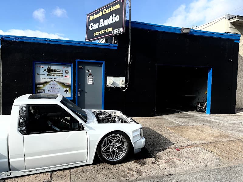 Black storefront with a white pickup truck parked outside at Asbeck Custom Car Audio LLC in Wilmington, Delaware