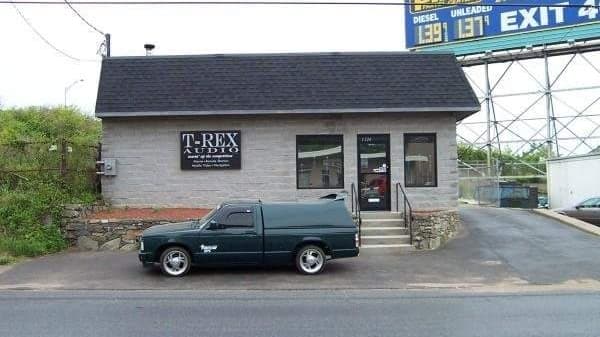 Storefront with T-Rex Audio sign and green pickup truck at T-Rex Audio LLC in Stratford, Connecticut