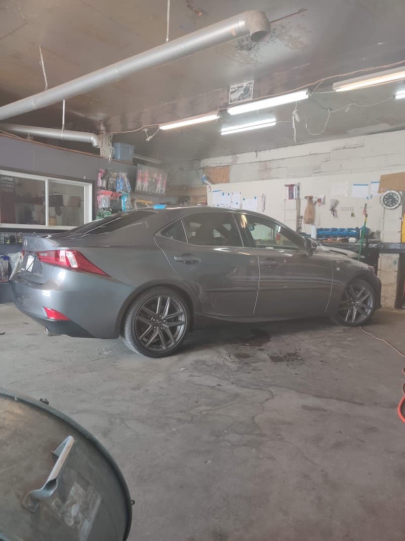 Gray sedan with dark wheels parked inside a garage at Loco Audio in Avondale, Pennsylvania