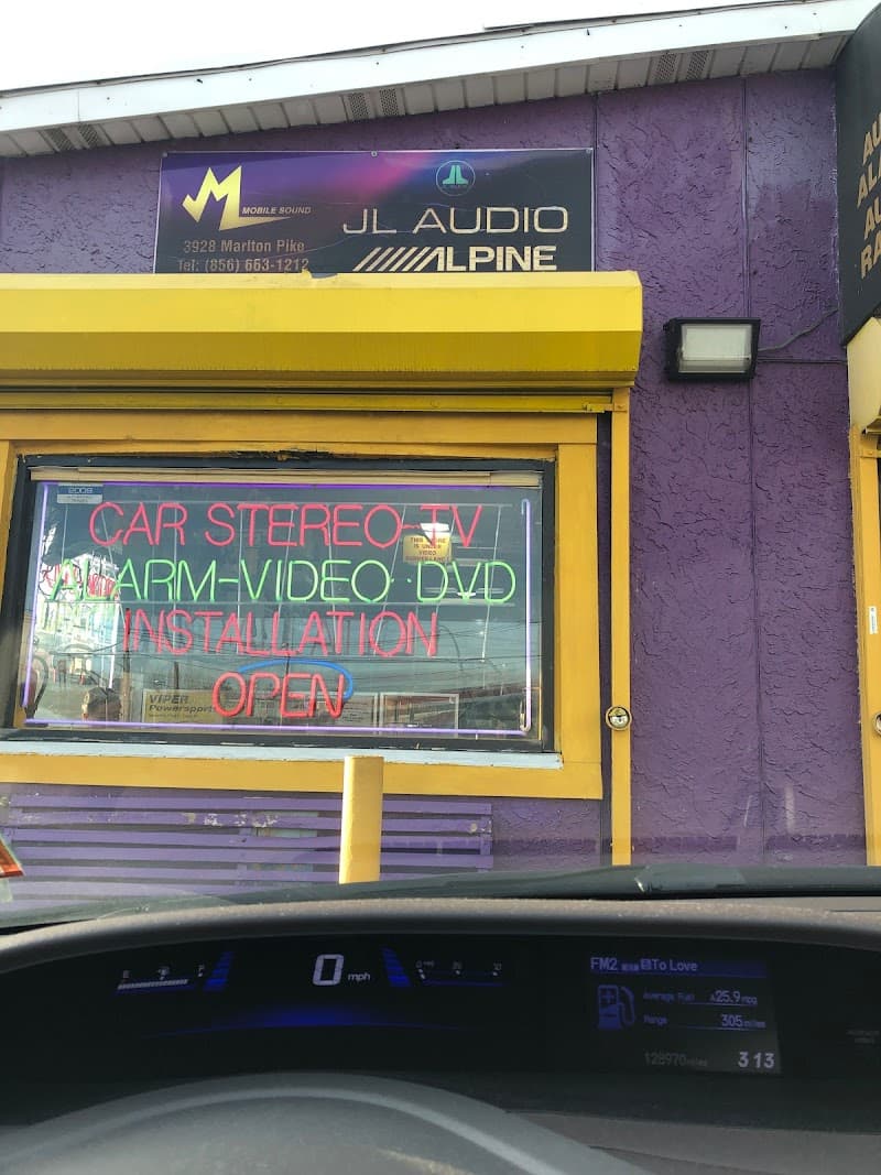 Storefront with neon car stereo and alarm sign at Mobile Sound & Alarm Co Inc in Pennsauken Township, New Jersey
