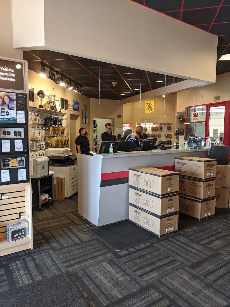 Sales counter with stacked speaker cartons and staff behind it at Car Toys in Northglenn, Colorado