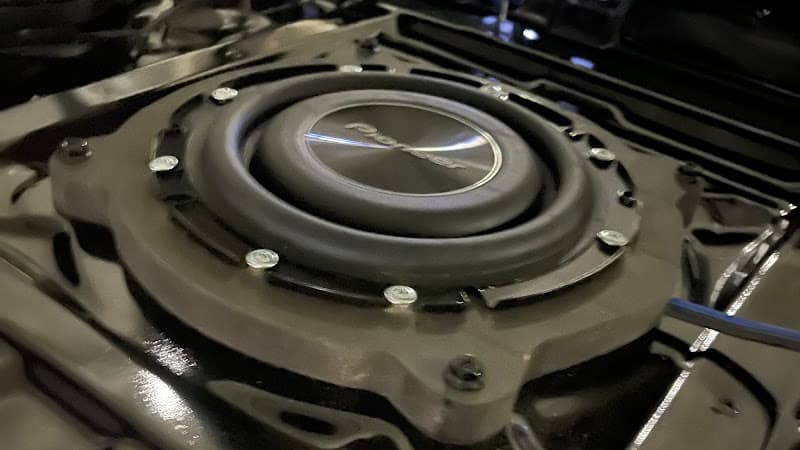 Pioneer subwoofer mounted in a vehicle floor panel at AJ Electronics Chicago in Lyons, Illinois