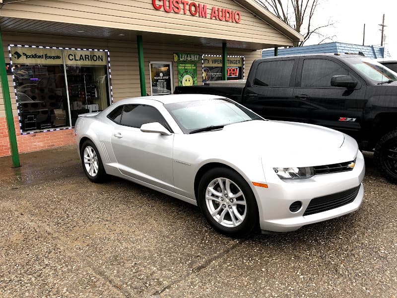 Silver coupe parked by Rockford Fosgate and Clarion windows at Custom Audio of Madisonville in Madisonville, Kentucky