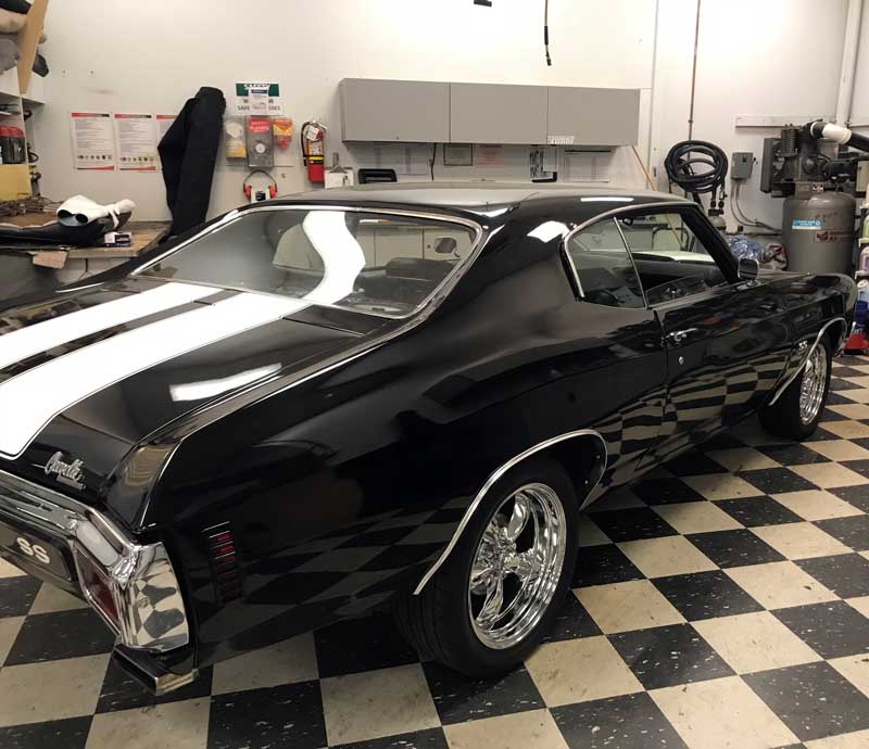 Black Chevelle coupe with white stripes in a workshop at Tun Design in Fort Collins, Colorado