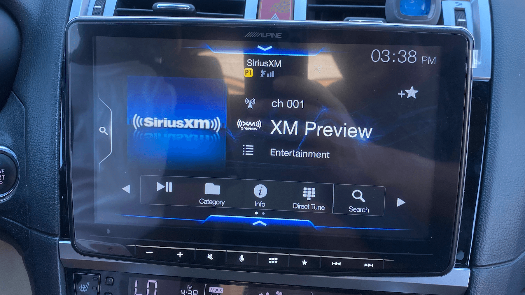 Alpine touchscreen stereo showing SiriusXM radio in a car dash at Pacific Sound in Cathedral City, California