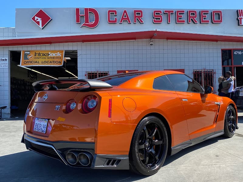 Orange sports coupe parked in front of a shop at HD Car Stereo in Hawthorne, California