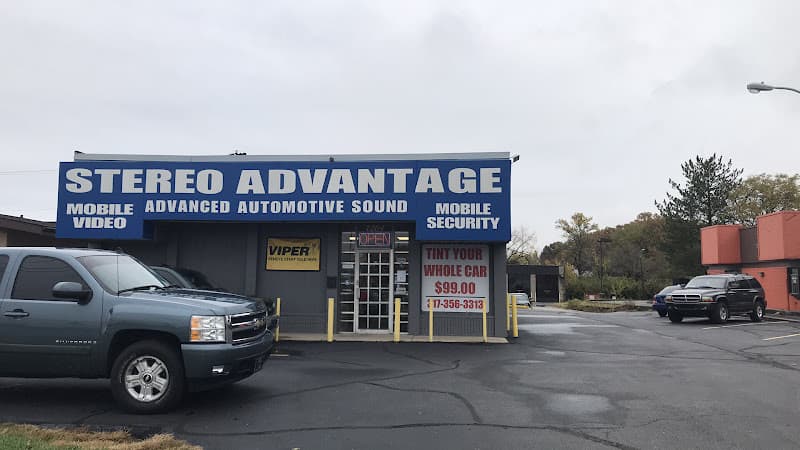 Storefront with blue sign and gray pickup parked out front at Stereo Advantage in Indianapolis, Indiana