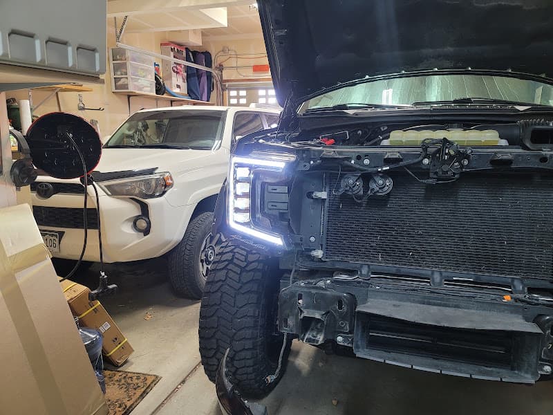 Truck with open hood and LED headlights in a garage at Jay's Audio/Video Installation in Parker, Colorado