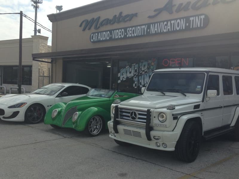 Storefront sign and three parked cars out front at MASTER AUDIO & SECURITY in Houston, Texas