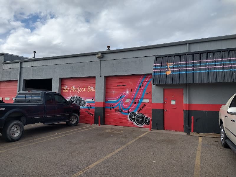 Red roll-up bay doors with speaker mural and music notes at The perfect beat 505 in Albuquerque, New Mexico
