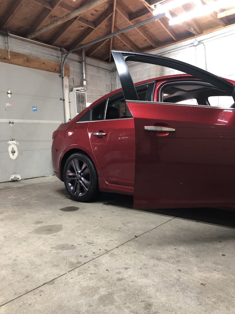 Red sedan with an open door in a garage at JOEL'S POWERBASS in Cicero, Illinois