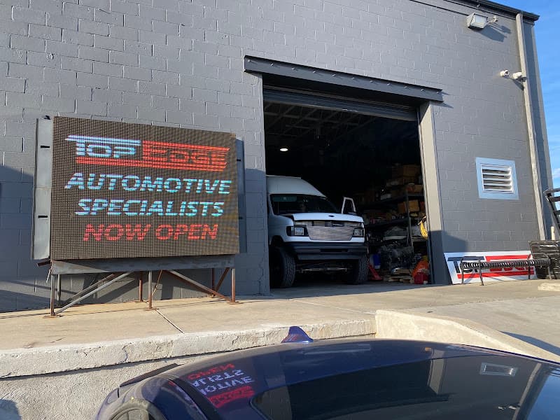 LED sign by garage bay with white van at Top Edge: Car Audio, Truck Accessories & Hot Rod Installation in Denver, Colorado
