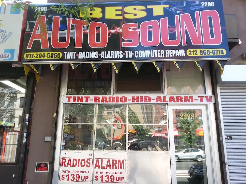 Storefront with tint, radio and alarm price signs at Best Auto Sound in New York, New York