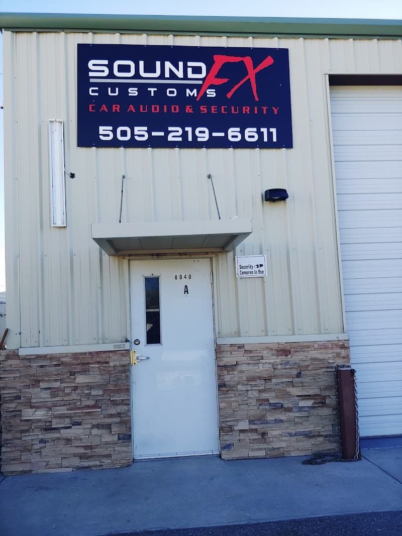 Building exterior with navy sign and roll-up bay door at Sound Customs FX in Albuquerque, New Mexico