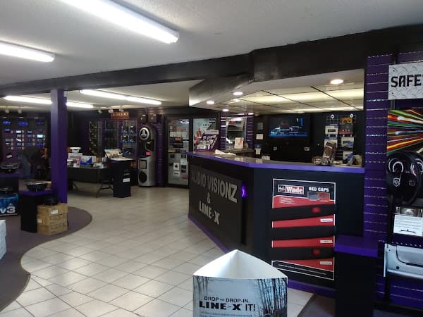Showroom counter with purple trim and Line-X sign at Audio Visionz by Midwest Truck Accessories in Mt Vernon, Illinois