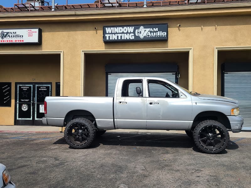 Silver lifted pickup truck parked by the storefront at 7AM AUDIO and WINDOW TINTING in Vernon, California