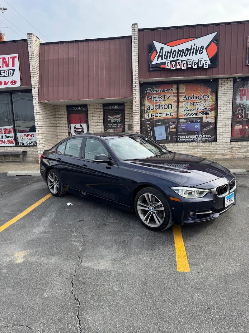 Dark blue BMW sedan parked in front of storefront at Automotive Concepts in Crestwood, Illinois