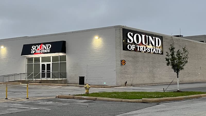 White building exterior with black entrance awning and wall sign at Sound of Tri-State in Wilmington, Delaware