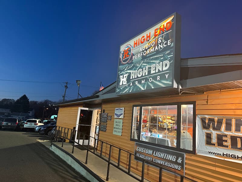 Illuminated sign above a tan storefront in the evening at Highend Audio & Performance in Williamstown, New Jersey